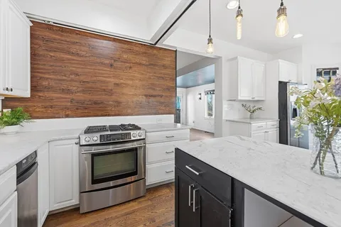 a kitchen with a stove and a refrigerator