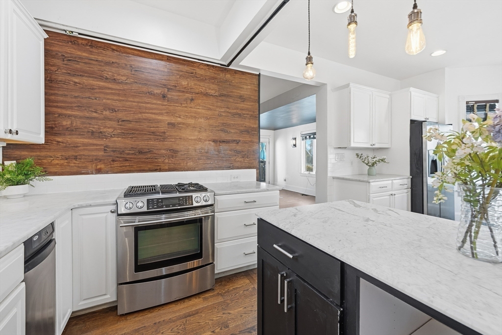 22 Spring Street Everett, MA 02149 - Photo 13 of 40 a kitchen with a stove and a refrigerator