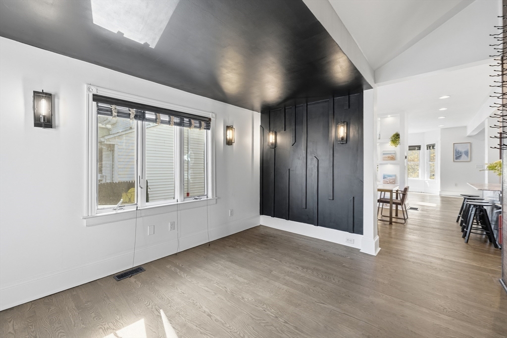 22 Spring Street Everett, MA 02149 - Photo 14 of 40 an empty room with wooden floor and windows