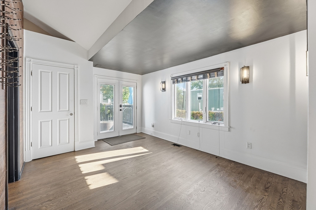 22 Spring Street Everett, MA 02149 - Photo 15 of 40 an empty room with wooden floor and windows