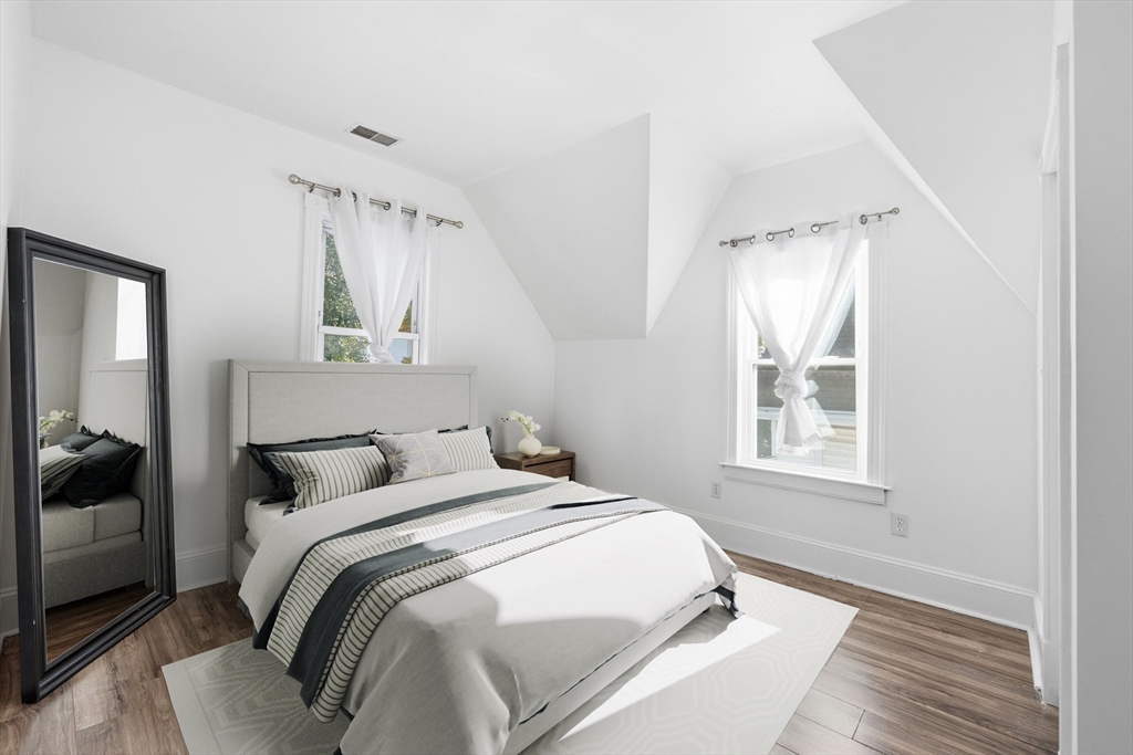 22 Spring Street Everett, MA 02149 - Photo 22 of 40 a bedroom with a bed and a window