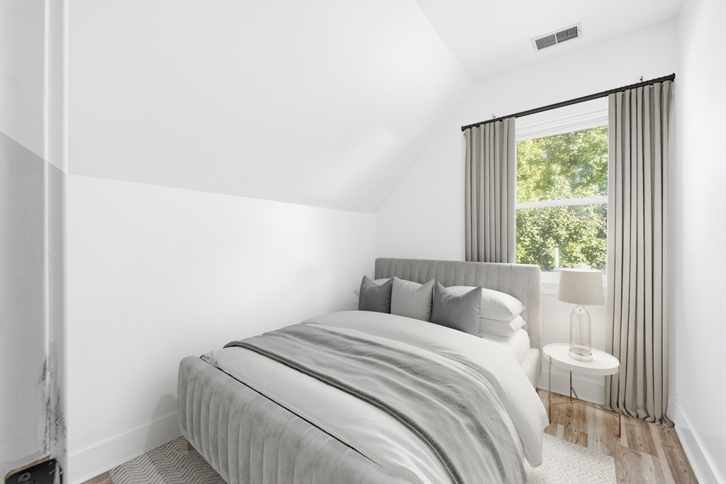 22 Spring Street Everett, MA 02149 - Photo 24 of 40 a bedroom with a bed and a window