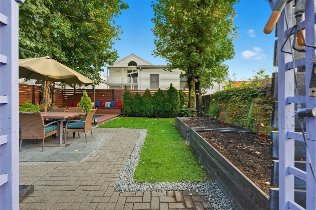 22 Spring Street Everett, MA 02149 - Photo 29 of 40 a view of a chair and table in backyard of the house