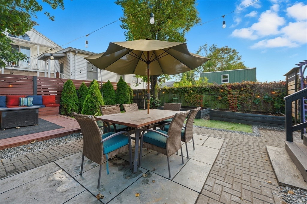 22 Spring Street Everett, MA 02149 - Photo 30 of 40 a view of backyard with seating space and plants