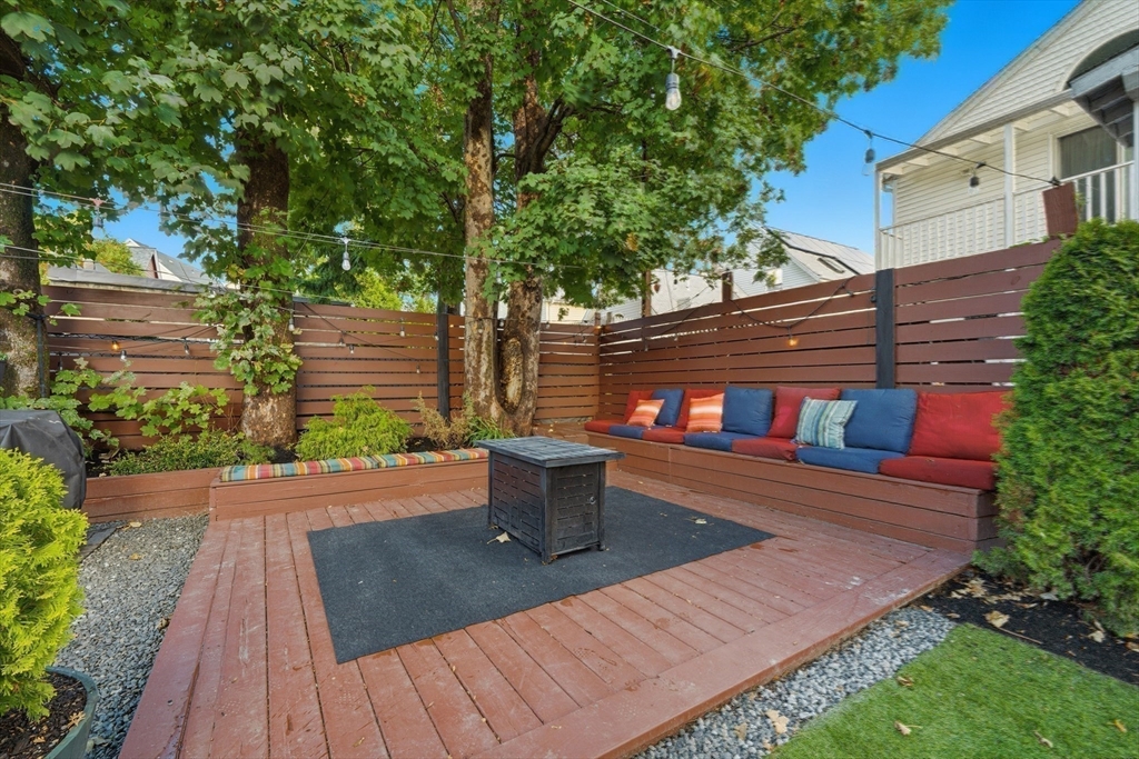22 Spring Street Everett, MA 02149 - Photo 33 of 40 a backyard of a house with wooden floor yard and outdoor seating