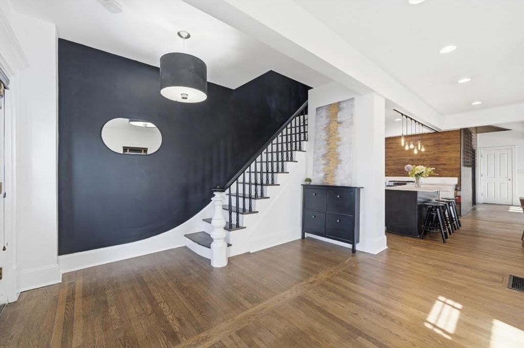 22 Spring Street Everett, MA 02149 - Photo 4 of 40 a view of a hallway with wooden floor and seating space