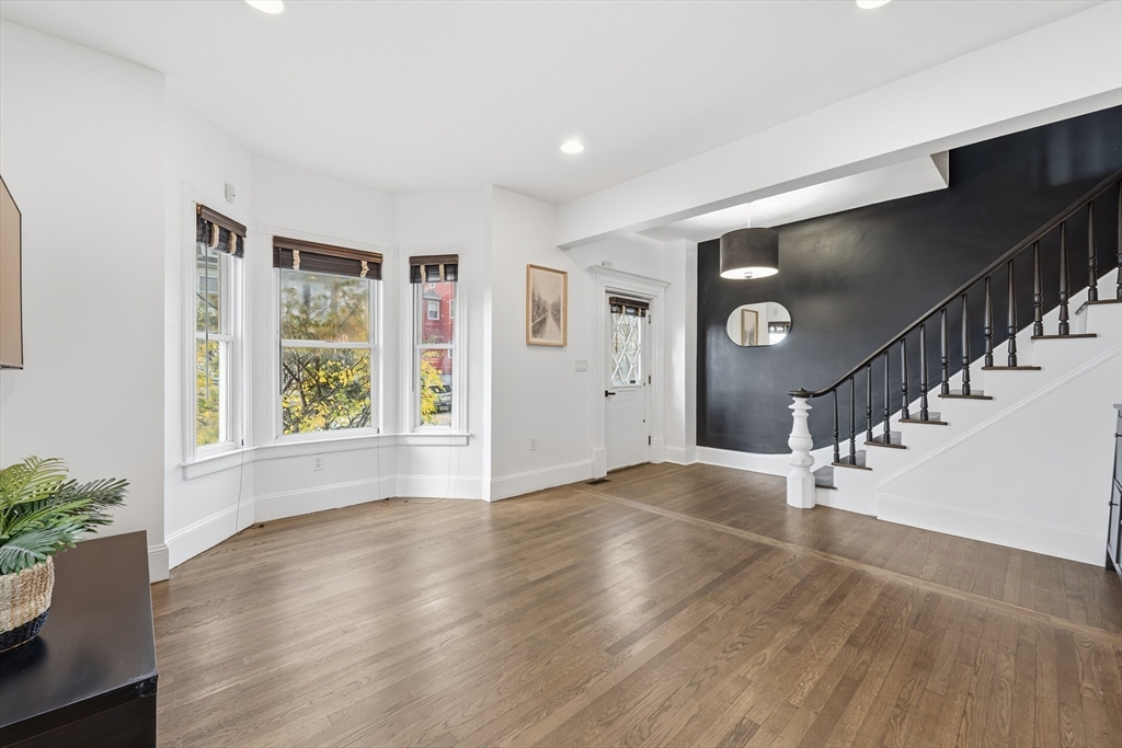 22 Spring Street Everett, MA 02149 - Photo 5 of 40 a view of an empty room with wooden floor and a window