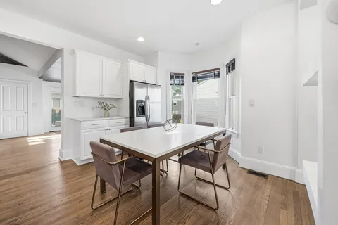 a view of a dining room with furniture and wooden floor