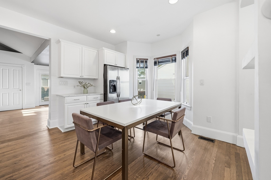 22 Spring Street Everett, MA 02149 - Photo 9 of 40 a view of a dining room with furniture and wooden floor