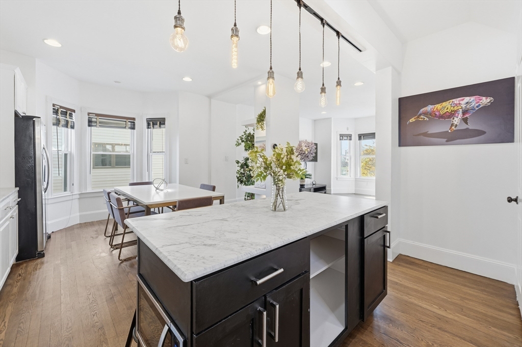 22 Spring Street Everett, MA 02149 - Photo 10 of 40 a kitchen with a table and chairs in it