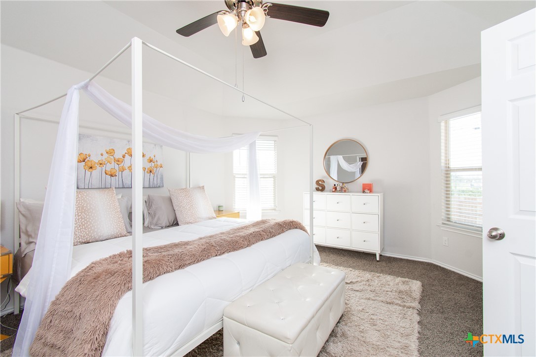 8415 Cantera Rdg Road Temple, TX 76502 - Photo 14 of 24 a bedroom with a bed and a chandelier