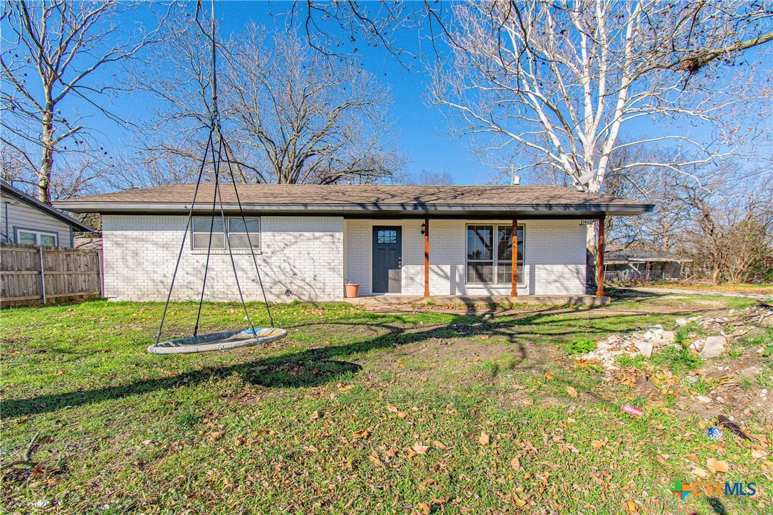 8415 Cantera Rdg Road Temple, TX 76502 - Photo 24 of 24 a backyard of a house with table and chairs under an umbrella