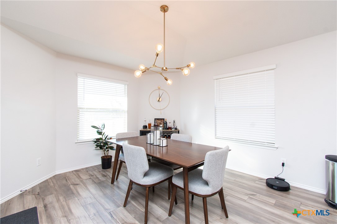 8415 Cantera Rdg Road Temple, TX 76502 - Photo 7 of 24 a view of a dining room with furniture and wooden floor