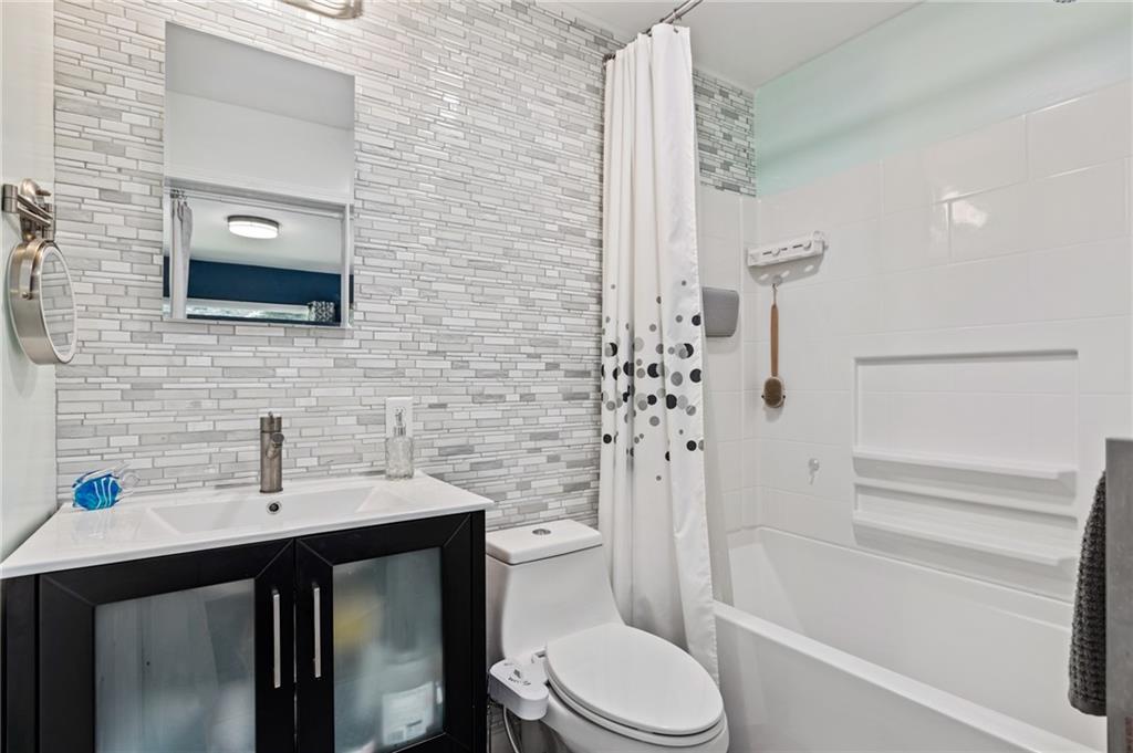 8287 Tanglewood Road Pittsburgh, PA 15237 - Photo 22 of 25 a bathroom with a sink a toilet and shower
