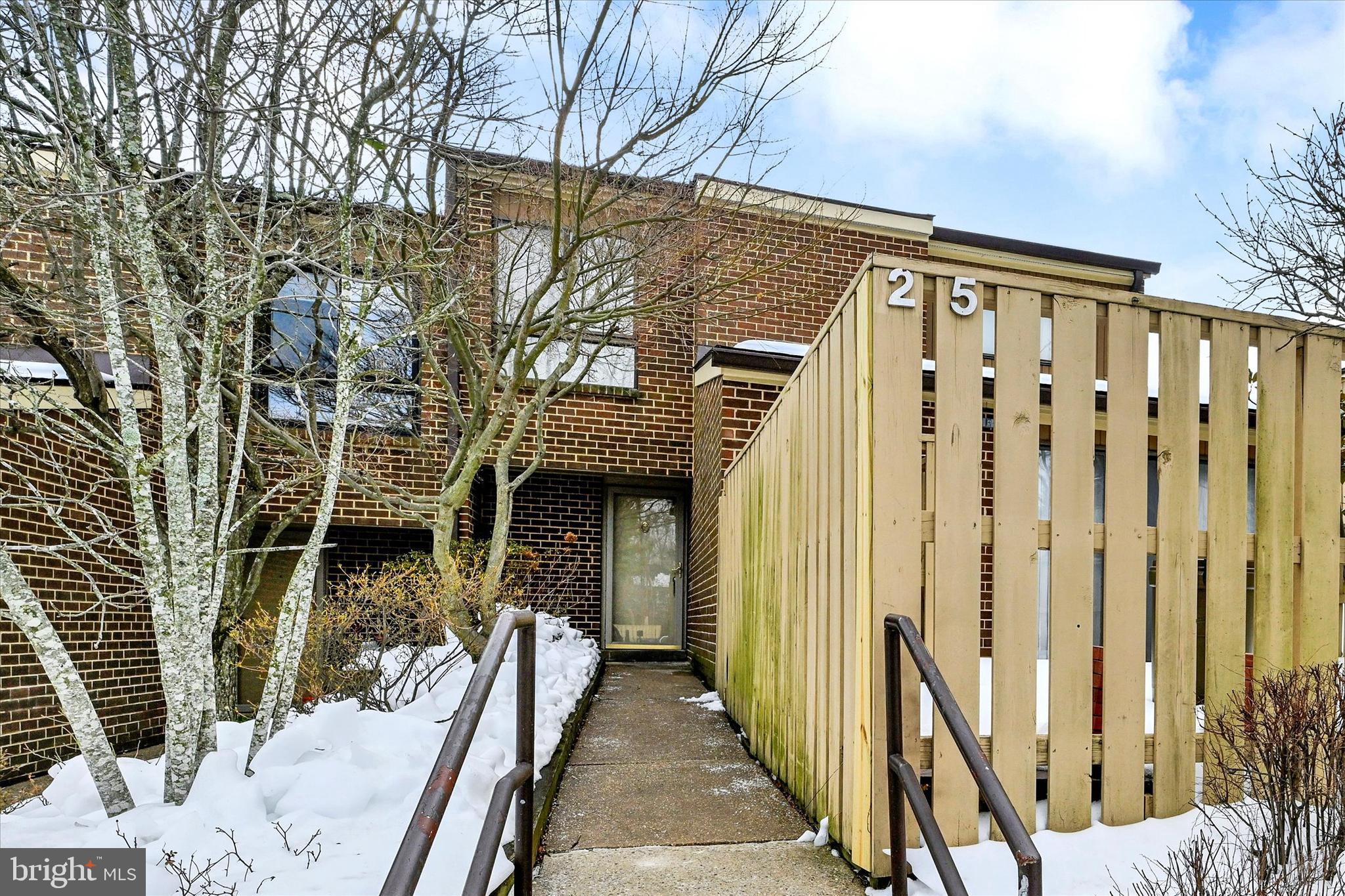 25 Tanner Court, Unit H Baltimore, MD 21208 - Photo 1 of 29 a view of a house with a wooden fence