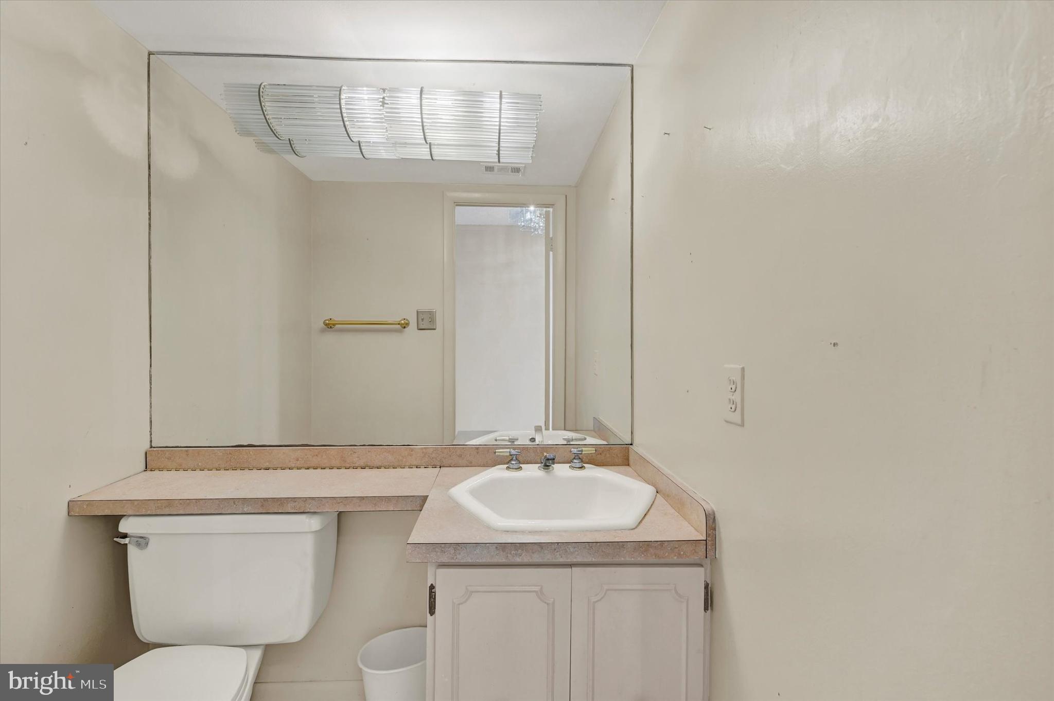 25 Tanner Court, Unit H Baltimore, MD 21208 - Photo 13 of 29 a bathroom with a granite countertop sink toilet and a mirror