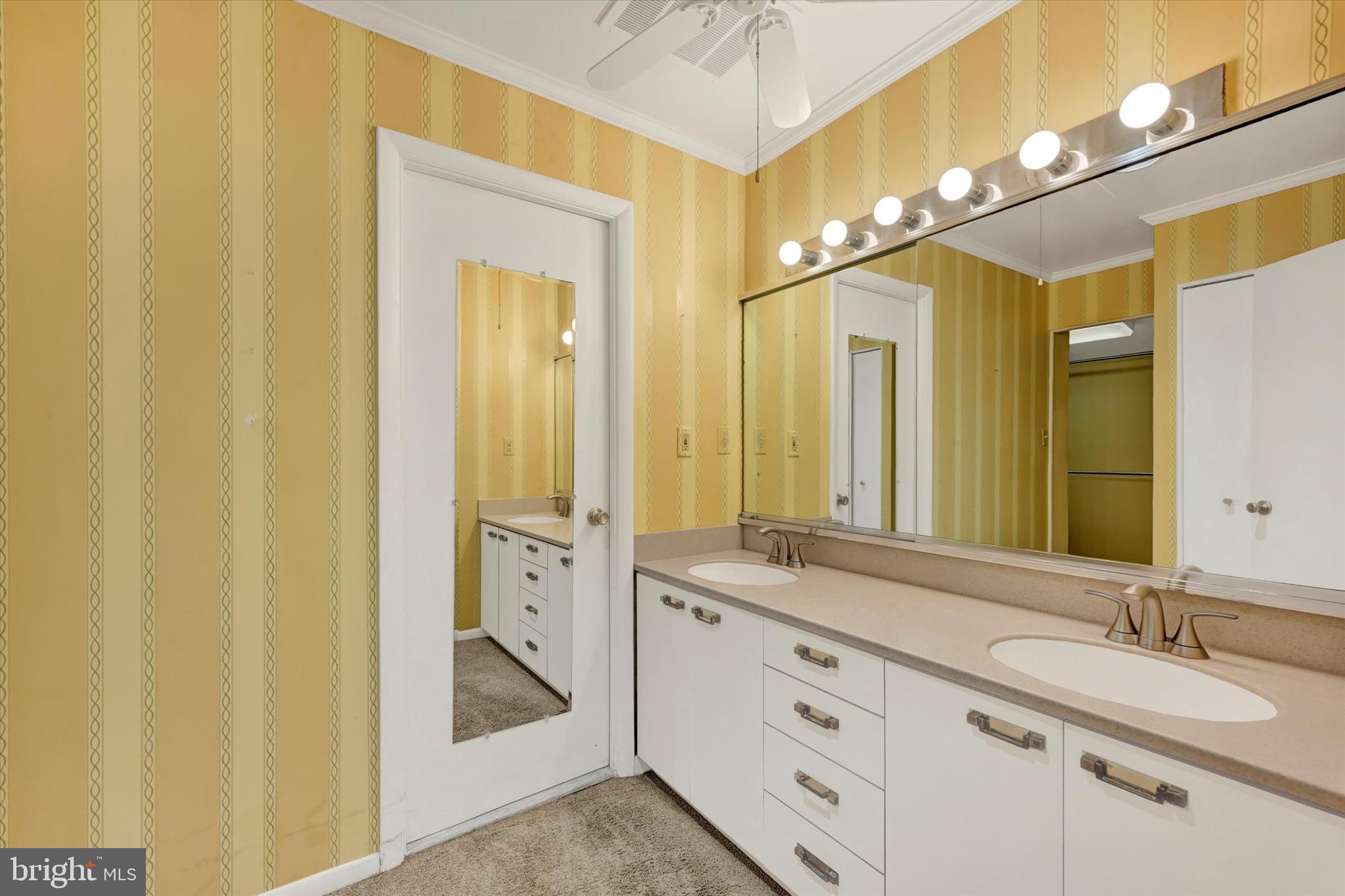 25 Tanner Court, Unit H Baltimore, MD 21208 - Photo 20 of 29 a spacious bathroom with a double vanity sink and a mirror