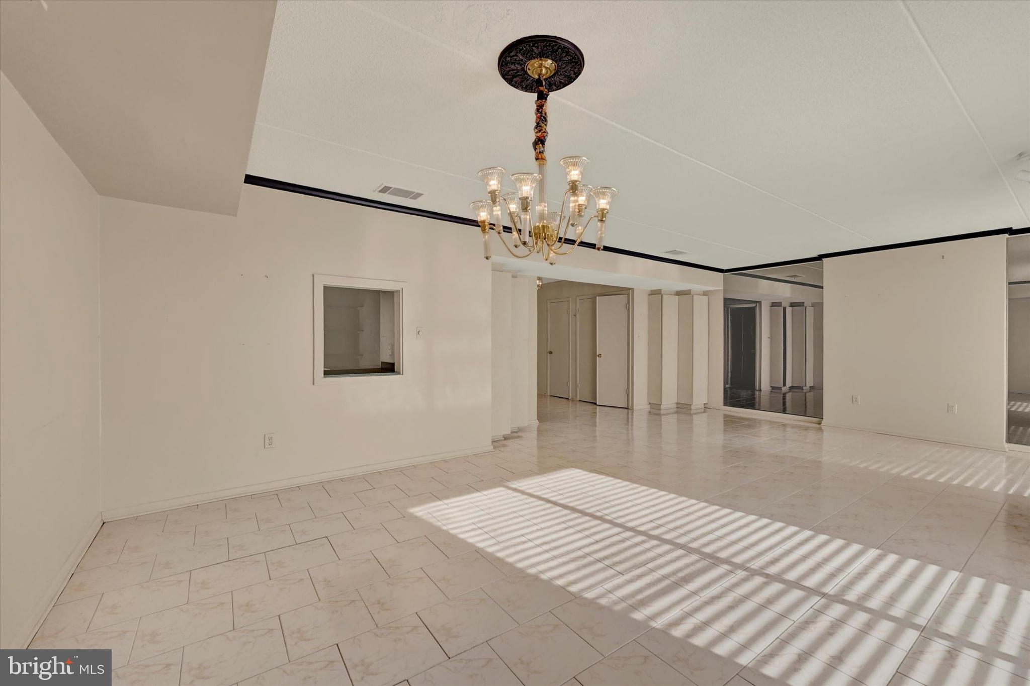 25 Tanner Court, Unit H Baltimore, MD 21208 - Photo 7 of 29 a view of a room with wooden floor and chandelier