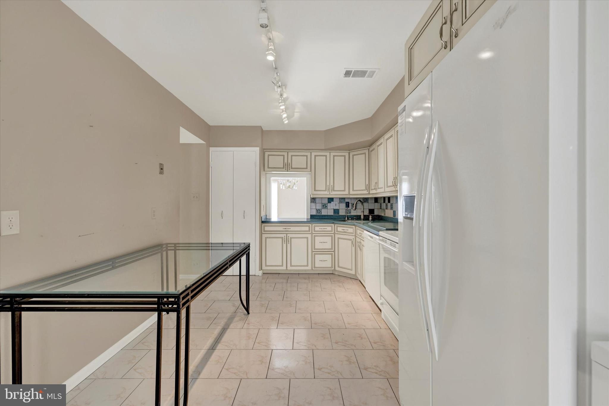 25 Tanner Court, Unit H Baltimore, MD 21208 - Photo 9 of 29 a kitchen with white cabinets and white appliances