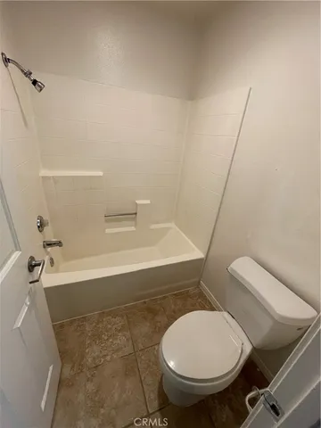 a bathroom with a toilet and a bath tub