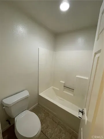a white toilet sitting next to a bathroom sink