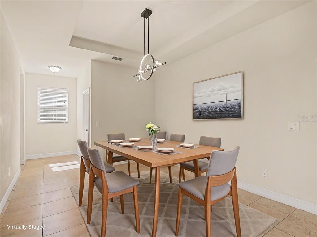 4429 Conchfish Lane Osprey, FL 34229 - Photo 7 of 20 a view of a dining room with furniture and wooden floor