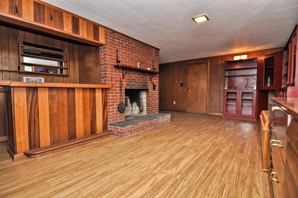 80 Goldthwaite Road Northbridge, MA 01588 - Photo 21 of 28 an empty room with wooden floor and a fireplace