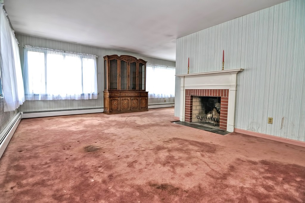 80 Goldthwaite Road Northbridge, MA 01588 - Photo 8 of 28 an empty room with fireplace and windows