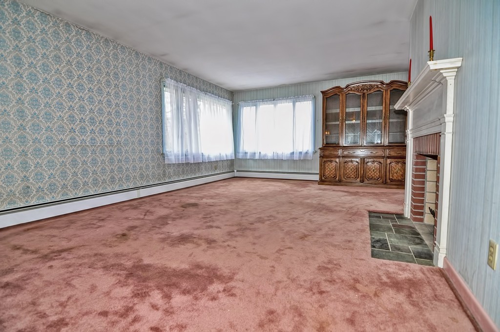 80 Goldthwaite Road Northbridge, MA 01588 - Photo 9 of 28 a view of empty room with a fireplace and windows