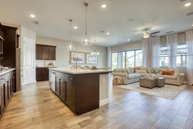 a dining room with furniture a chandelier and wooden floor
