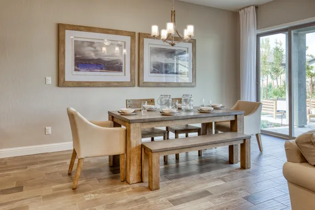a dining room with furniture and wooden floor