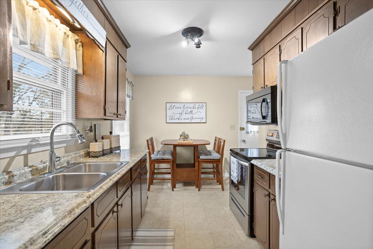 2321 Meadowbrook Road Northwest Roanoke, VA 24017 - Photo 11 of 25 a kitchen with granite countertop a sink a counter top space and stainless steel appliances