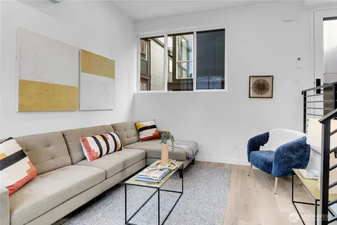 a living room with furniture and a potted plant