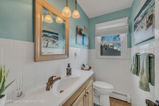 a bedroom with a bed and a flat tv screen on dresser