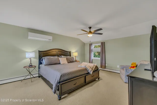 a bedroom with furniture and a wooden floor