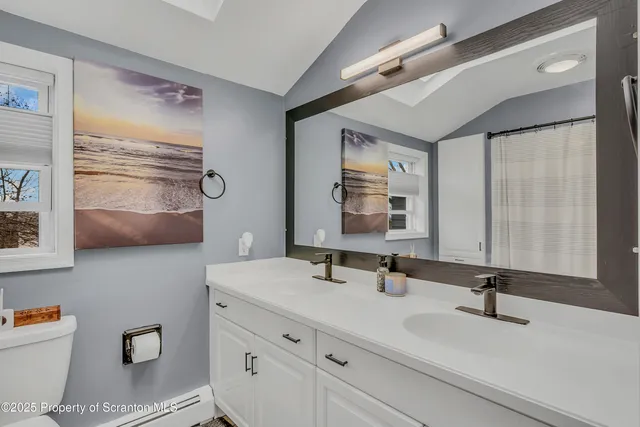 a bathroom with a granite countertop bathtub shower and toilet
