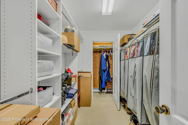 a bedroom with a bed and a flat tv screen on dresser