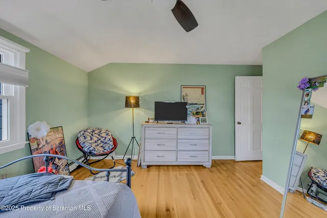 a bathroom with a granite countertop sink and a toilet