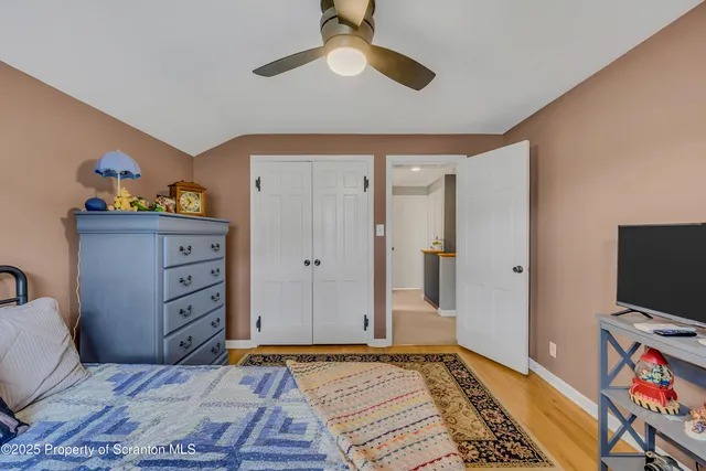 a living room with furniture and a kitchen area