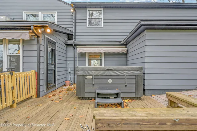 a view of backyard with a deck and wooden floor
