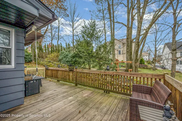 a living room with furniture a fireplace and a floor to ceiling window