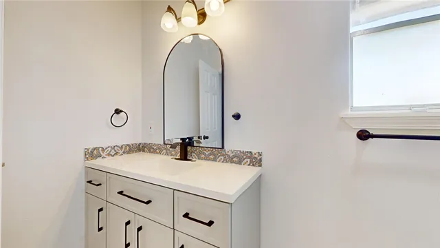 a bathroom with a sink and a mirror