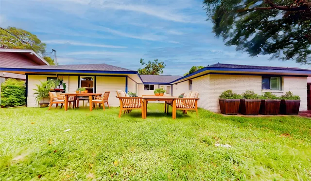 a view of swimming pool with outdoor seating and a garden