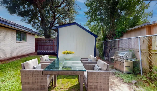 an aerial view of a house with outdoor space and sitting space