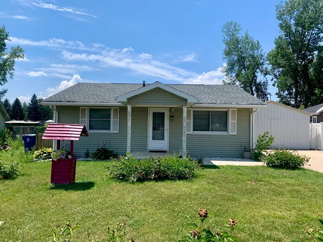 a front view of house with yard and outdoor seating