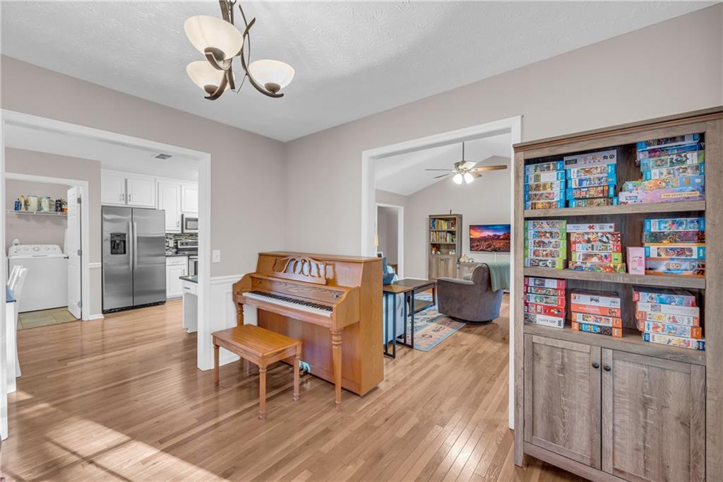 1670 Alcovy River Drive Dacula, GA 30019 - Photo 12 of 43 a living room with furniture and a book shelf