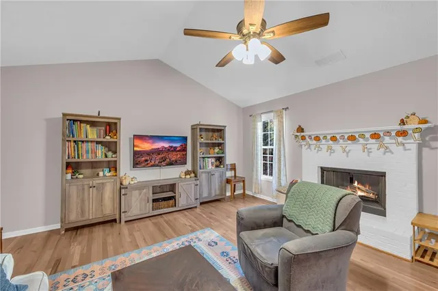 a view of a patio with table and chairs with wooden floor and fence