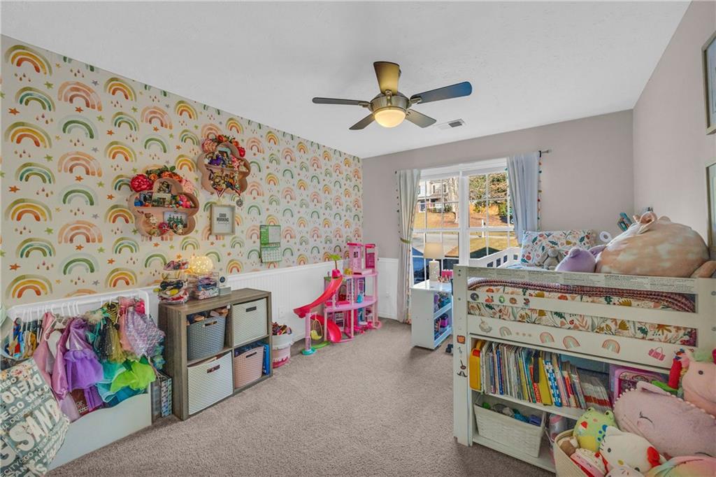 1670 Alcovy River Drive Dacula, GA 30019 - Photo 16 of 43 a bedroom with a bed and a chandelier