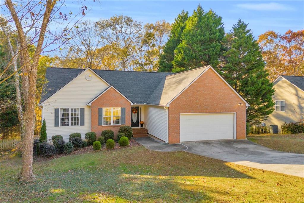 1670 Alcovy River Drive Dacula, GA 30019 - Photo 2 of 43 a front view of a house with a yard and garage