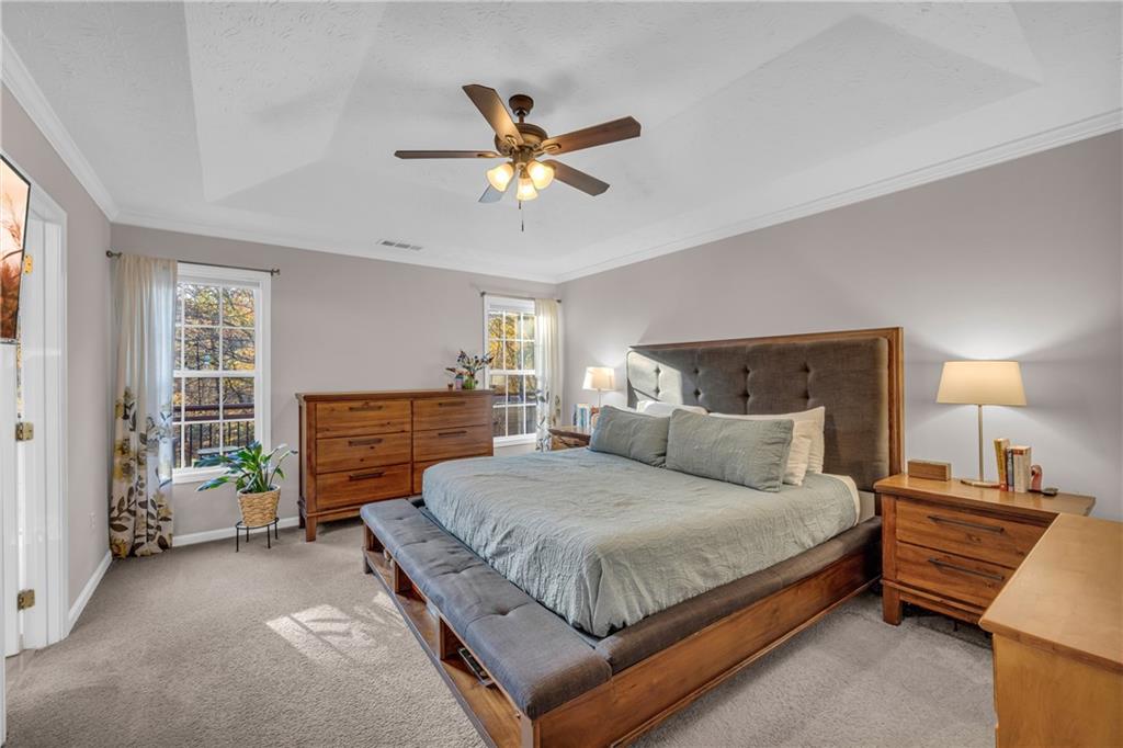 1670 Alcovy River Drive Dacula, GA 30019 - Photo 21 of 43 a bedroom with a bed and a chandelier